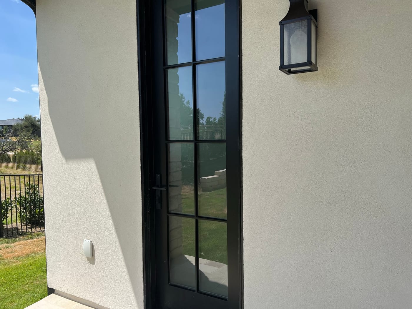 Clean stucco home exterior after soft washing in Central Texas